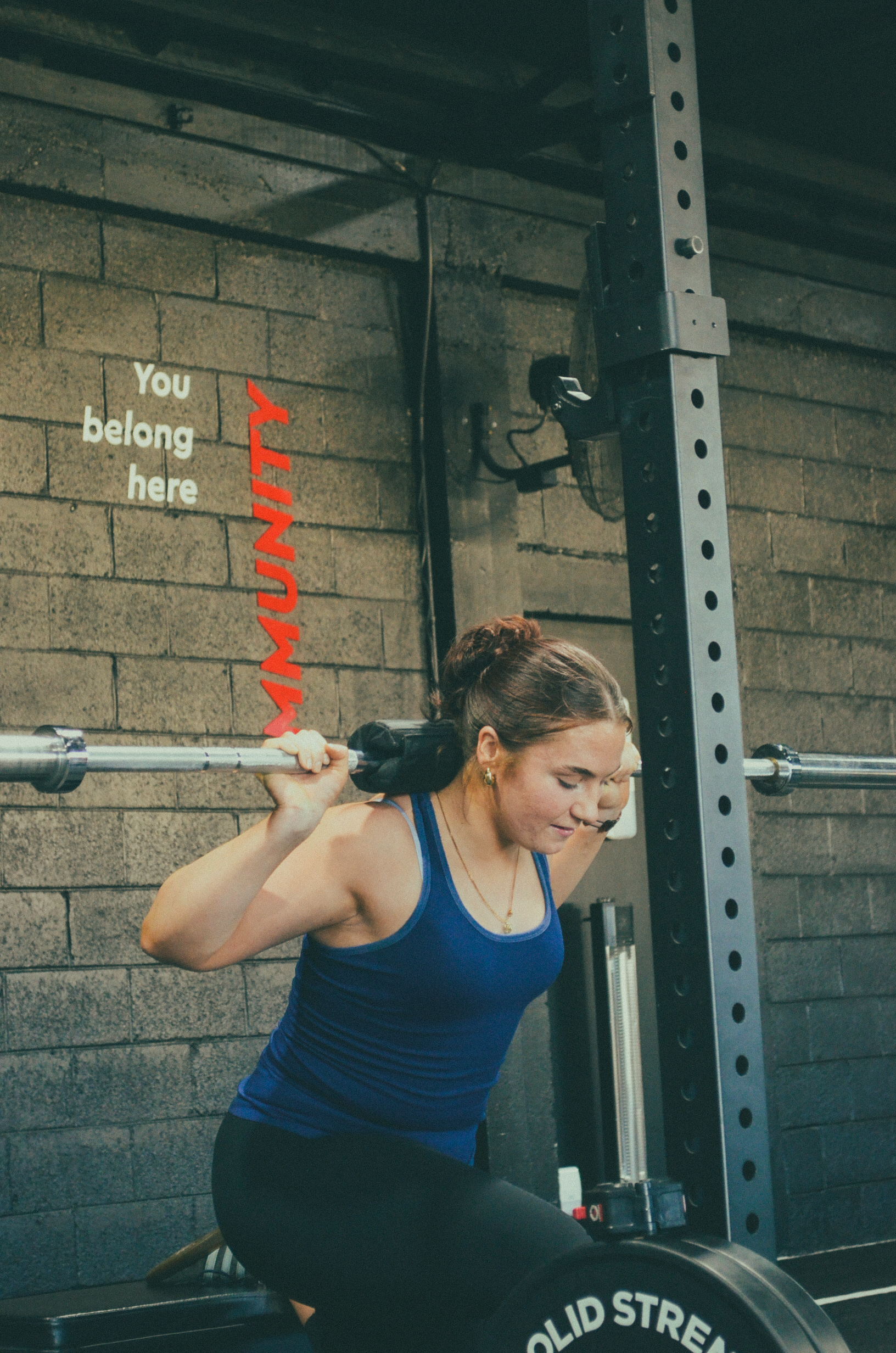 Pinnacle member performing a barbell squat